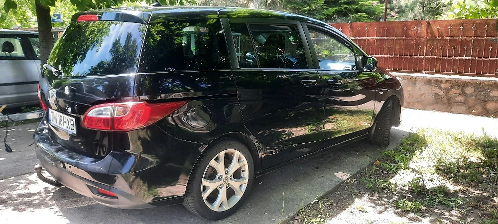 Vand mașina noastră  de familie Mazda 5 ,7 locuri ,cui remorca ,6 viteze pilot automat,etc  