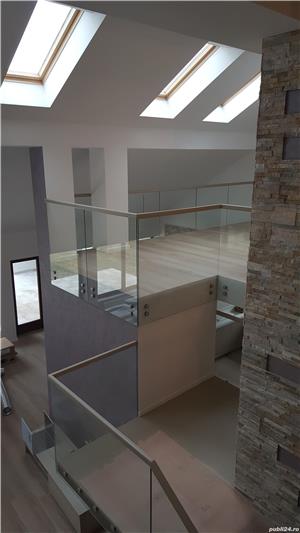 Balustradă cu sticlă securizată asamblată în conectori și cu mână curentă din lemn masiv lăcuită