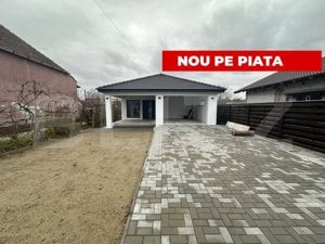 Casă cu 3 camere 130 mp, 1 bucătărie, 1 living, 2 băi, 1 garaj, curte.