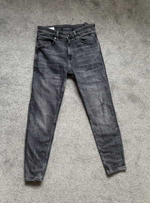 Blugi negri ușor elastici 