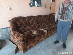 Acest fotoliu vintage are o tapițerie interesantă și o structură solidă din lemn. Poate fi o piesă d