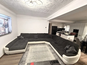 Colțar extensibil în U, cu ladă depozitare   385 cm, material + imitație piele, stare foarte bună